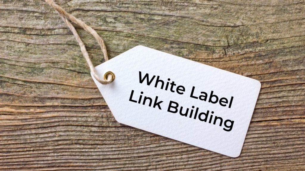 White Label Link Building tag on rustic wooden background, representing a service that provides quality link-building under a client's brand.